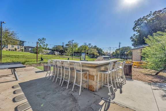 a patio with a bar and chairs around it  at Sunset Ridge, San Antonio