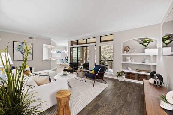 a living room with white walls and a sliding glass door