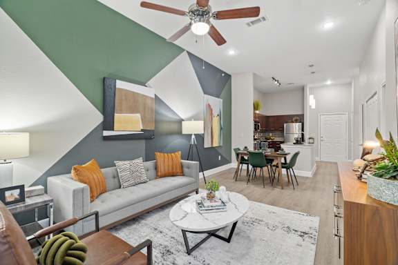 A living room with a grey couch and a coffee table.