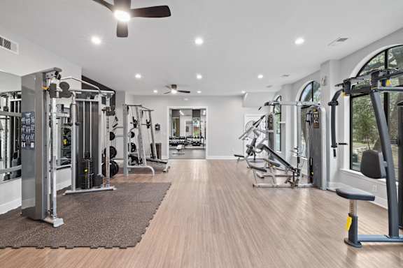 Fitness center with weight machines and strength equipment at Nalle Woods of Westlake Apartments, Austin, 78746