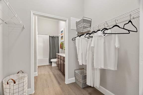 A laundry room with clothes hanging on a rack.