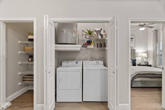 A small laundry room with a washer and dryer.