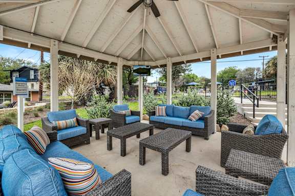 a covered patio with couches and tables  at Sunset Ridge, Texas, 78209