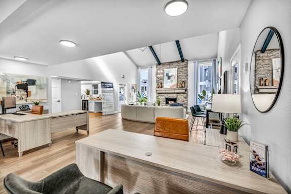 A modern office space with a reception desk and multiple workstations.