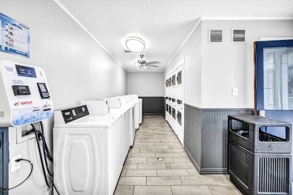 A row of washing machines in a laundromat.