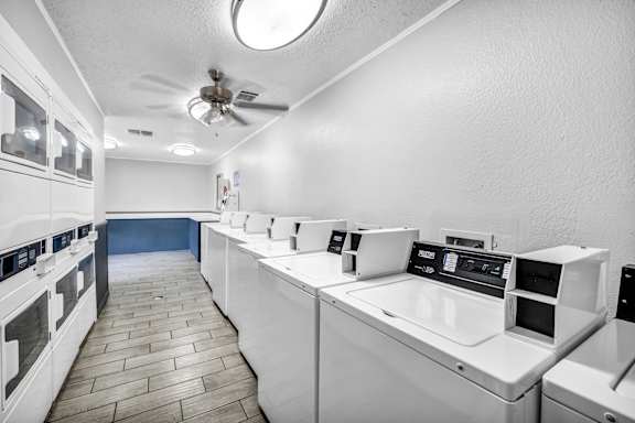 A kitchen with white appliances and a tile floor.