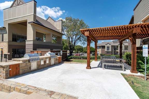 A modern building with a wooden pergola in front.