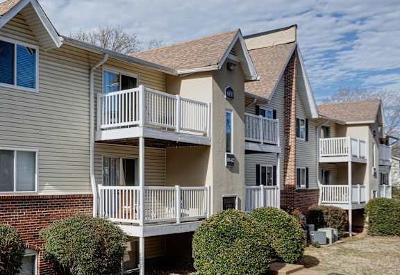 Apartment complex with a mix of brick and siding exteriors.