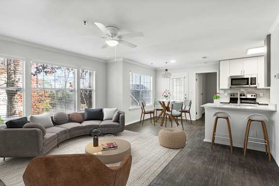 A modern living room with a grey sofa and a wooden coffee table.