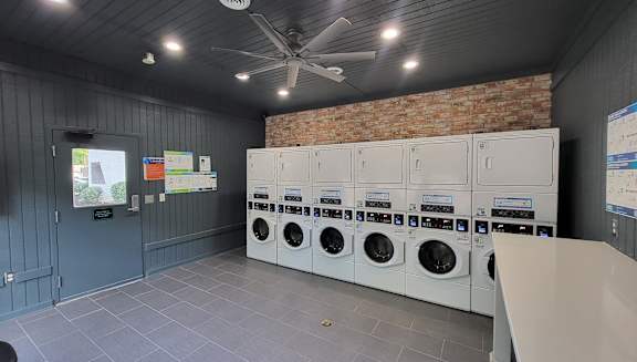 a laundry room with a bunch of washers and dryers