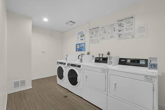 A wall of washing machines in a laundromat.