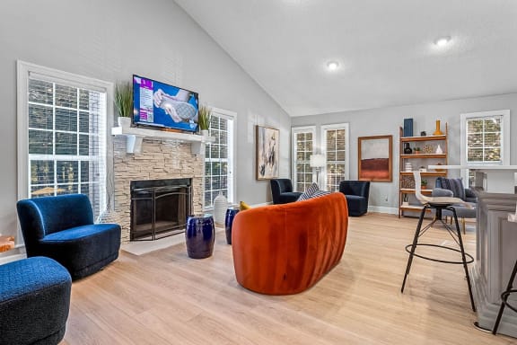 a living room with a fireplace and a tv above it