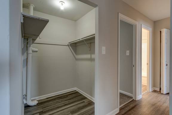 A white hallway with a door on the right.