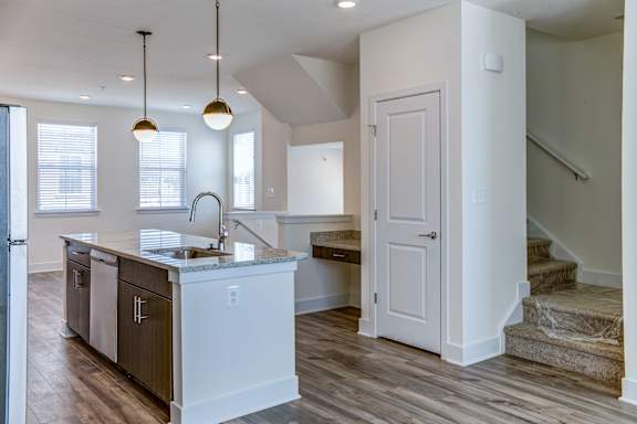 A kitchen with a sink and a counter.