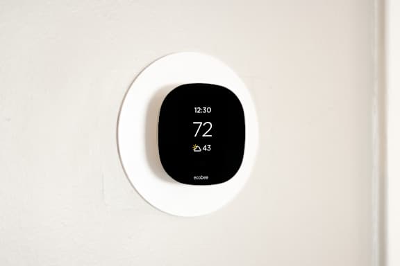 A thermostat shows the temperature as 72 degrees.
