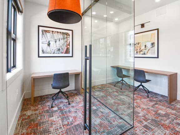 a conference room with glass walls and a table and chairs