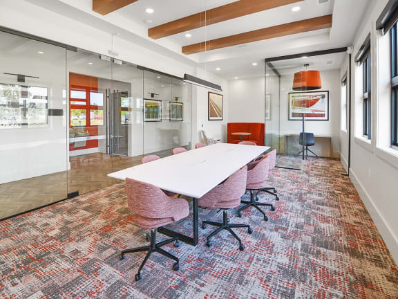a conference room with a white table and chairs