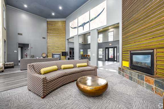 A modern living room with a large sofa and a television.