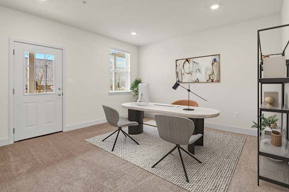 A room with a white table and chairs with a rug in front of it.