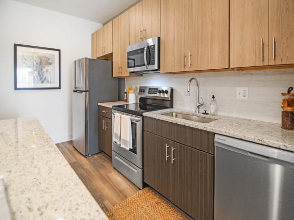 a kitchen with stainless steel appliances and wooden cabinets