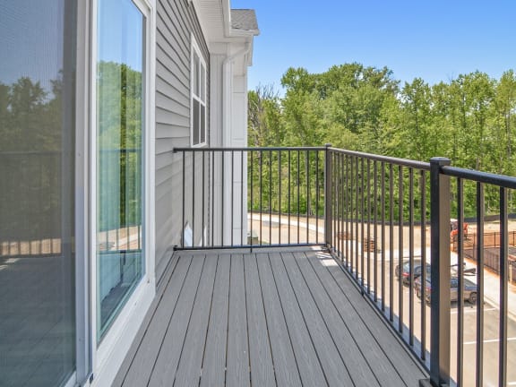 a balcony with a view of a house and trees