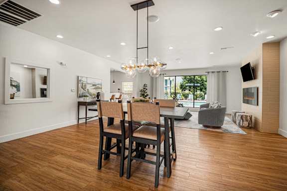 A dining room with a wooden table and chairs.