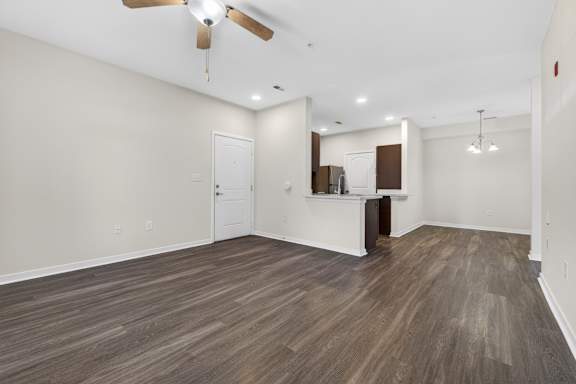 A room with a ceiling fan and lighting fixtures.