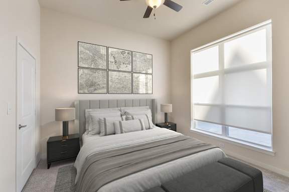 A bedroom with a large bed and a ceiling fan.