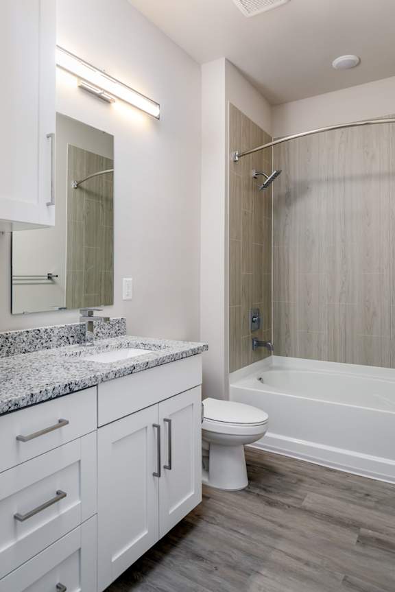 A white bathroom with a sink, toilet, and bathtub.