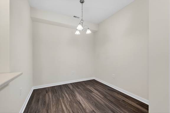 A room with wooden flooring and a light fixture.