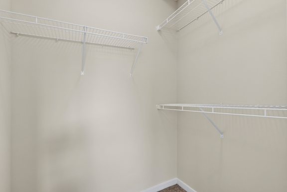 Empty white shelves in a room.