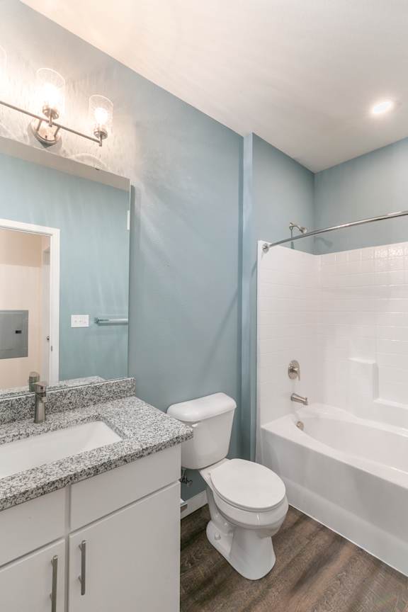 A bathroom with a toilet, sink, and bathtub.