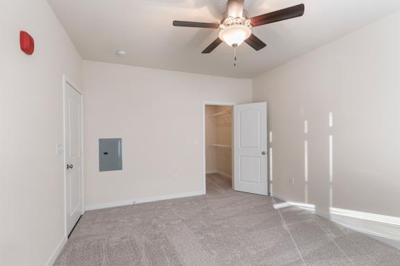 A room with a ceiling fan and a light fixture.