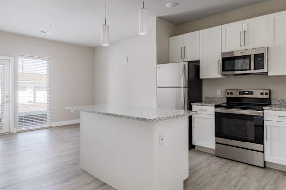 A kitchen with white appliances and cabinets.