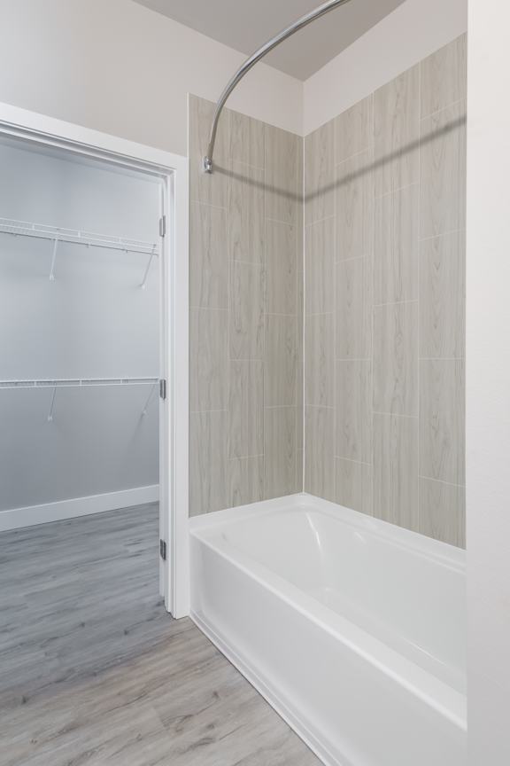 A white bathroom with a tub and a walk-in shower.
