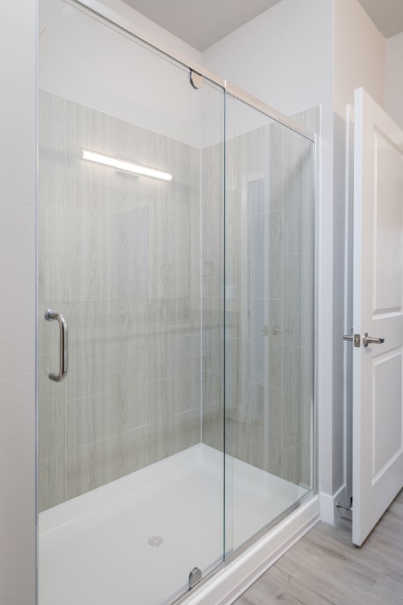 a shower with a glass door in a bathroom &#xA0;at The Edison at Farrow Commons, Myrtle Beach, SC, 29577