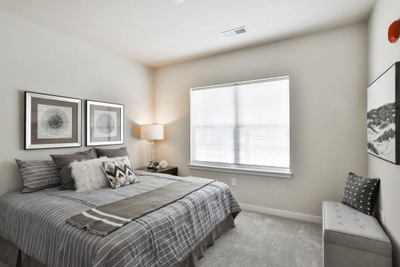a bedroom with a bed and a window  at Aventura at Hawk Ridge, Lake St Louis, MO
