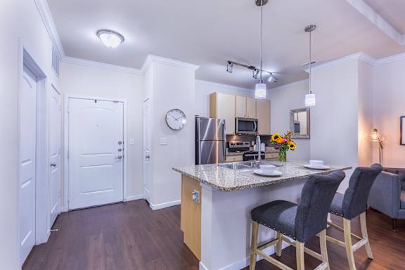 A kitchen with a bar stool and a counter.