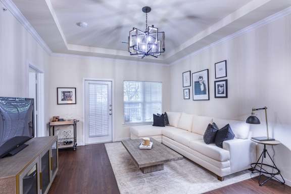 A living room with a white couch and a coffee table.