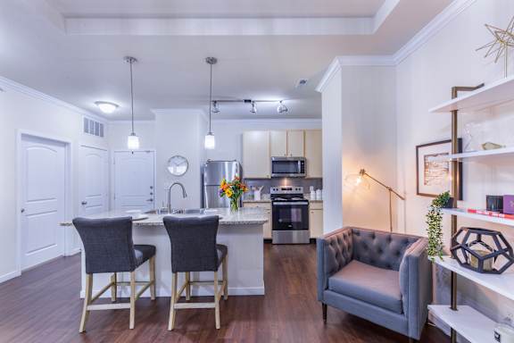 A modern kitchen with a dining table and chairs.