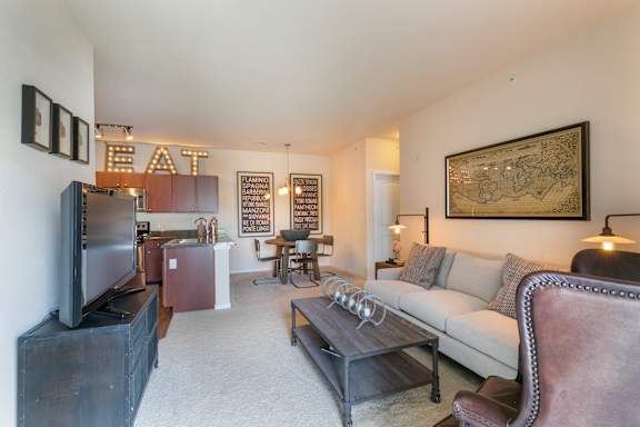 A living room with a couch, a television, and a coffee table.