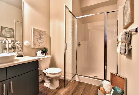 A bathroom with a toilet, sink, and shower.
