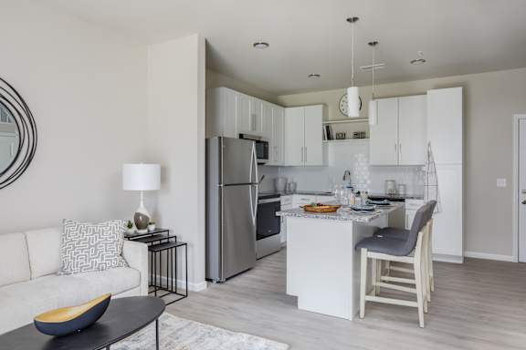 A modern kitchen with a dining table and chairs.