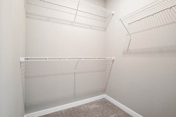 Empty white shelves in a room.