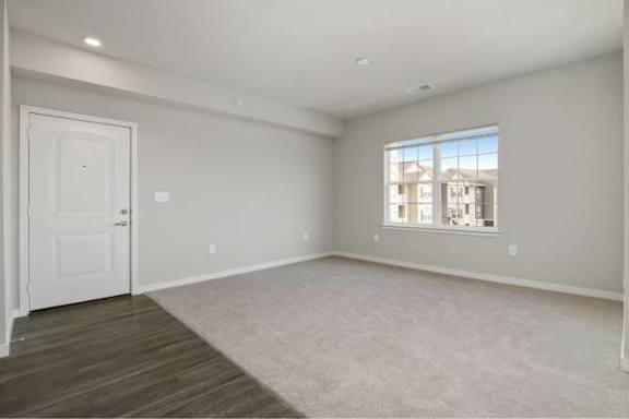 A spacious room with a door and a window at Aventura at Wentzville I & II Apartments, Wentzville, Missouri
