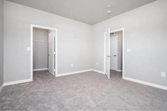 A room with two open doors and carpeted floor at Aventura at Wentzville I &amp; II Apartments, Wentzville, Missouri