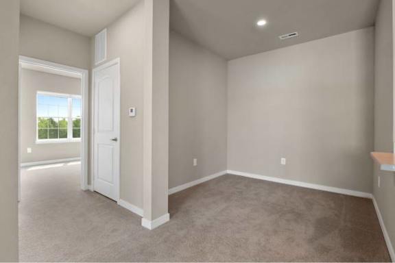 A room with a carpeted floor and a window at Aventura at Wentzville I &amp; II Apartments, Wentzville, 63385