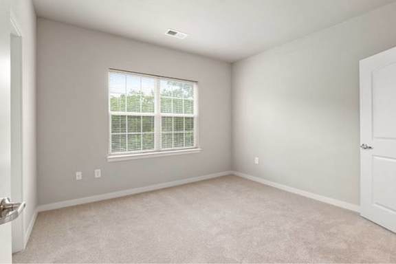 A room with a window and carpeted floor at Aventura at Wentzville I &amp; II Apartments, Wentzville, MO