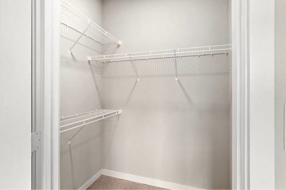 Empty white shelves in a white closet at Aventura at Wentzville I &amp; II Apartments, Missouri