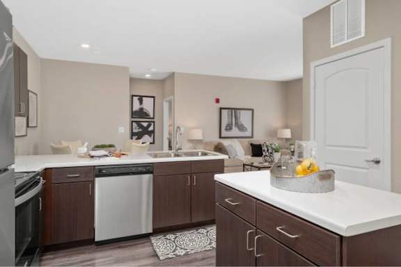 A kitchen with brown cabinets and a white countertop.